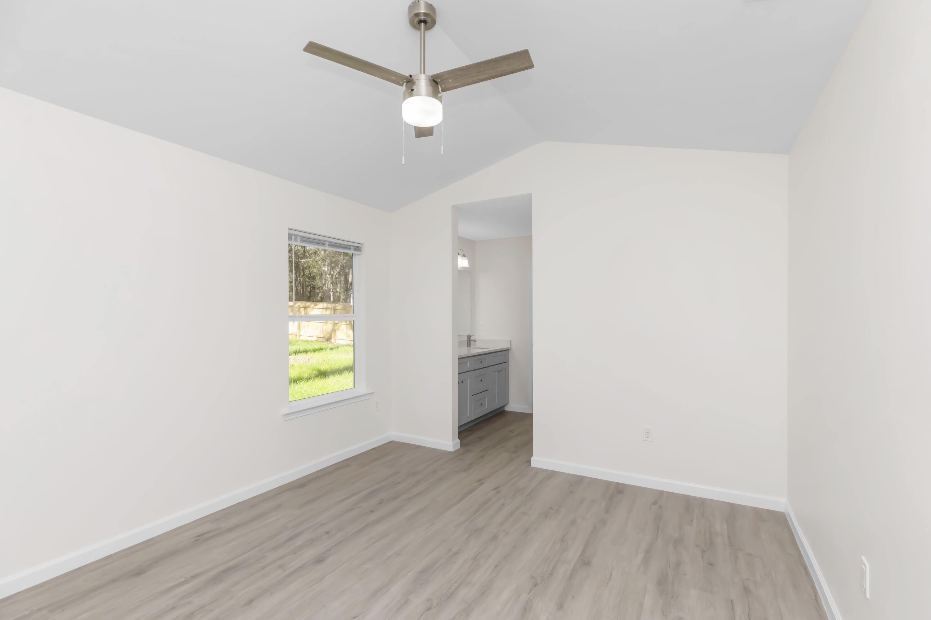 105 Beacons Bend Road Crestview, FL 32536 - Photo 38 of 52 an empty room with a window and wooden floor