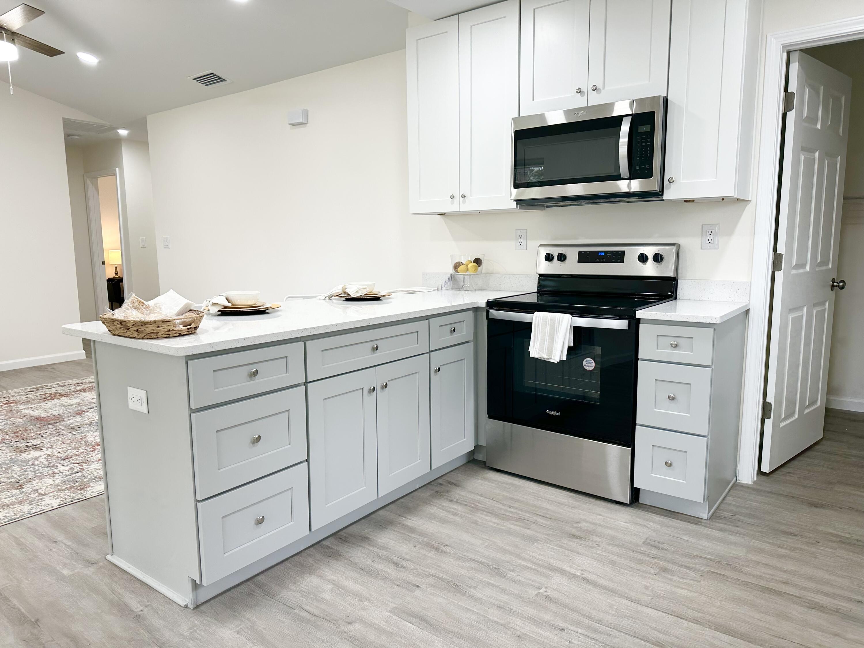 105 Beacons Bend Road Crestview, FL 32536 - Photo 5 of 52 a kitchen with stainless steel appliances granite countertop a stove a sink and a microwave