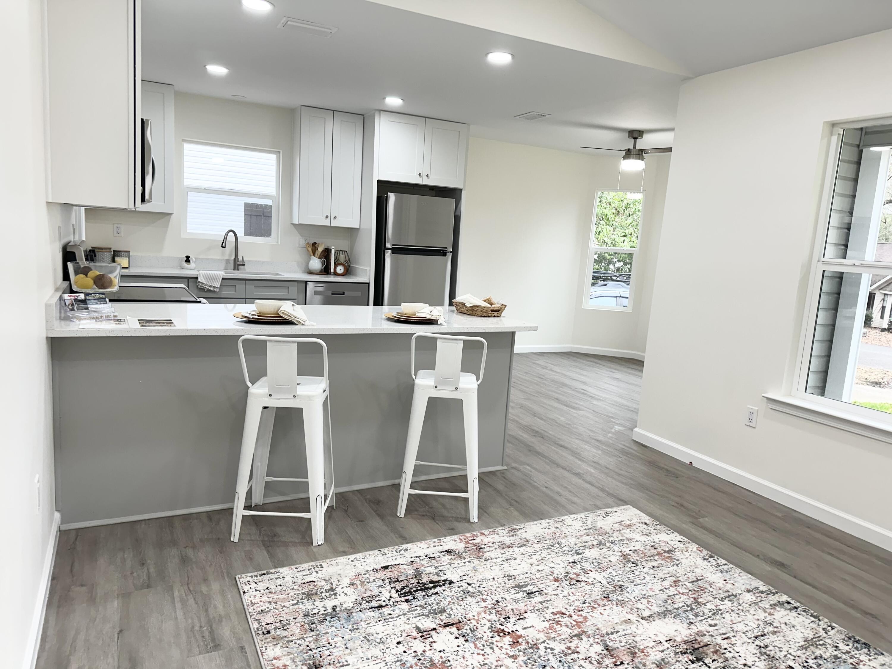 105 Beacons Bend Road Crestview, FL 32536 - Photo 8 of 52 a kitchen with a dining table chairs and refrigerator