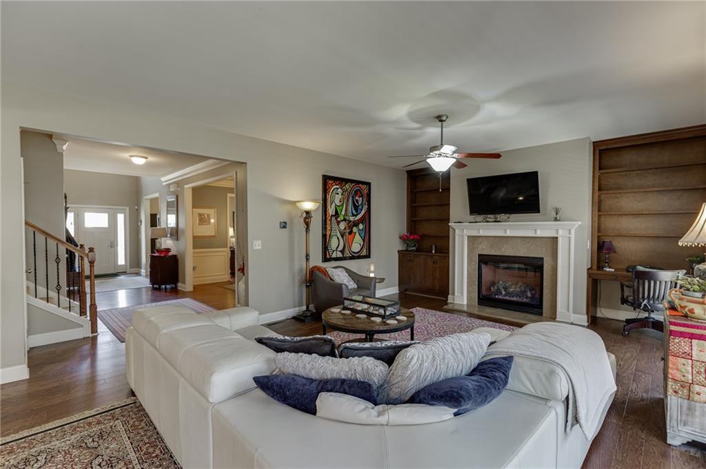 2201 Spring Sound Lane Buford, GA 30519 - Photo 12 of 66 a living room with furniture a fireplace and a flat screen tv