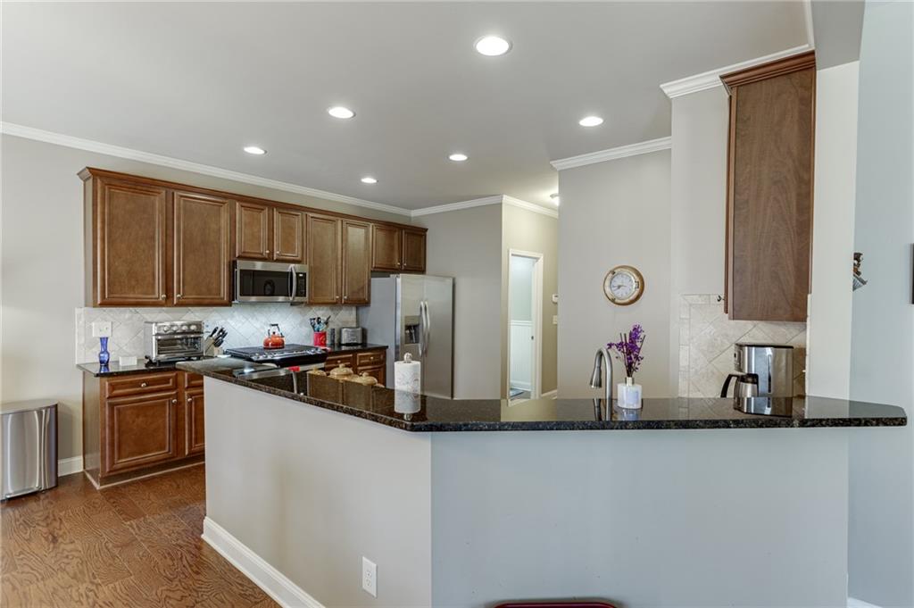 2201 Spring Sound Lane Buford, GA 30519 - Photo 19 of 66 a kitchen with stainless steel appliances a sink stove and refrigerator