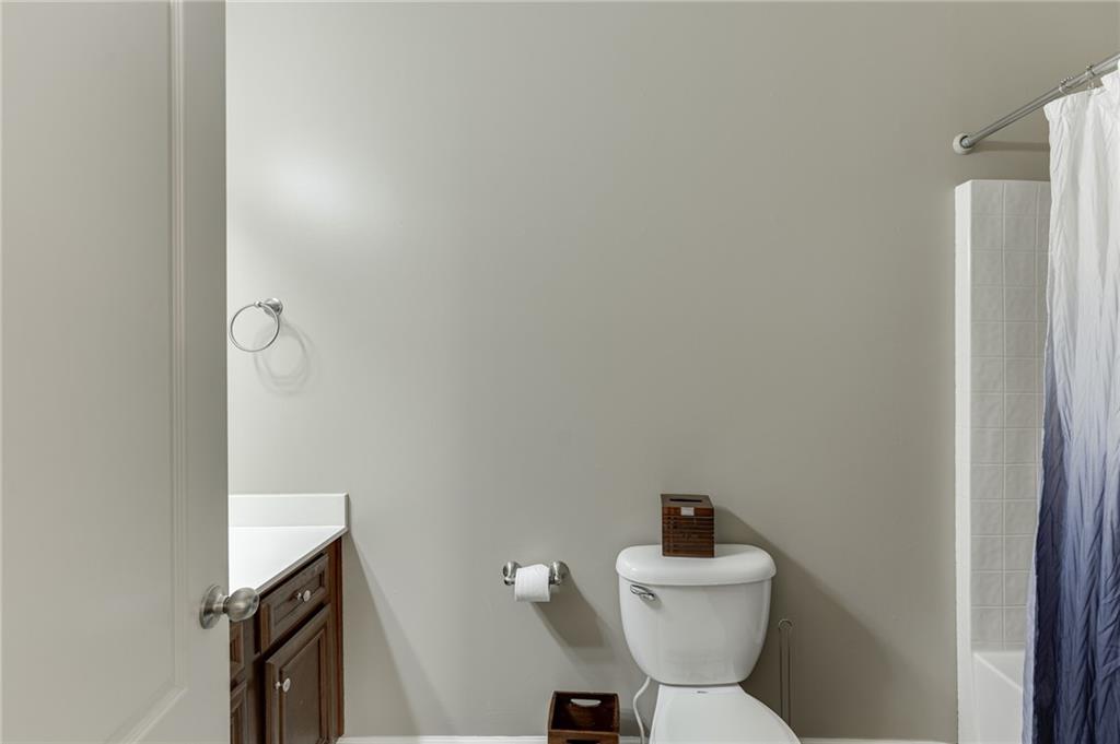 2201 Spring Sound Lane Buford, GA 30519 - Photo 27 of 66 a bathroom with a sink mirror toilet and vanity