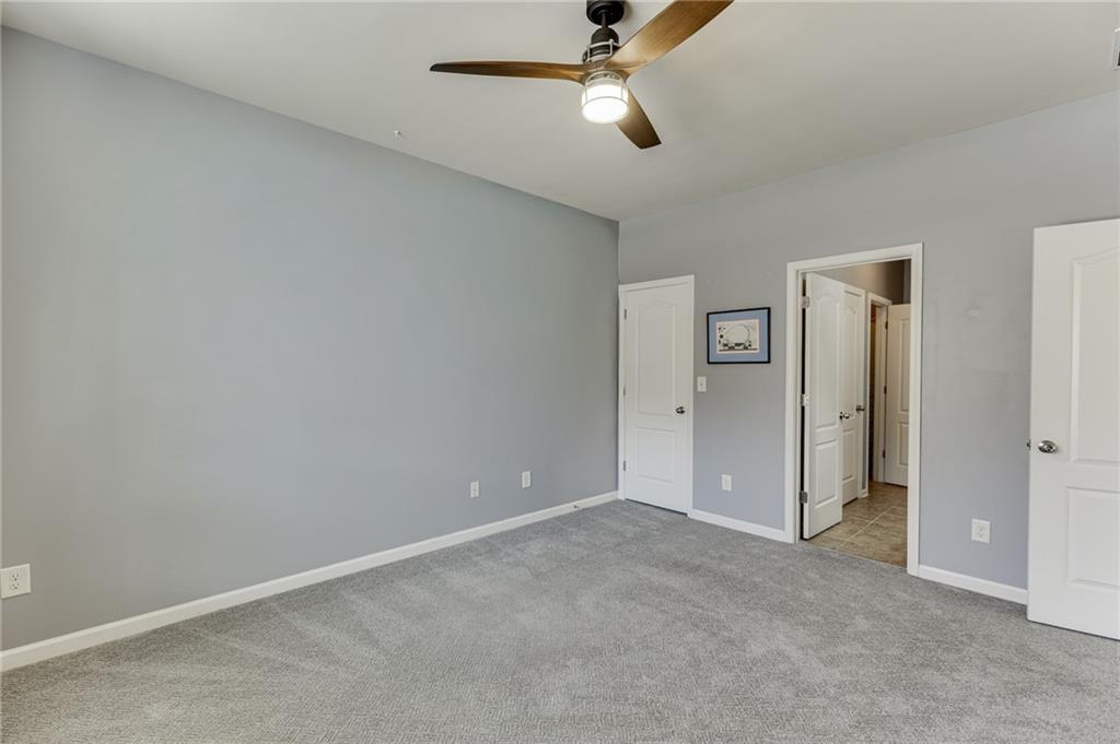 2201 Spring Sound Lane Buford, GA 30519 - Photo 31 of 66 an empty room with closet and a chandelier fan