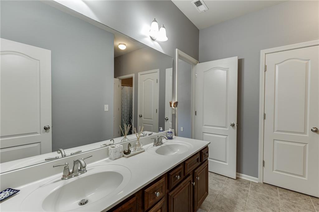 2201 Spring Sound Lane Buford, GA 30519 - Photo 32 of 66 a bathroom with a sink double vanity and a mirror