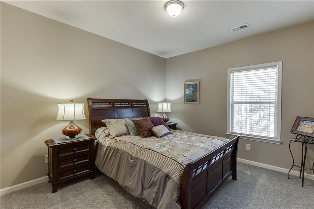 2201 Spring Sound Lane Buford, GA 30519 - Photo 33 of 66 a bedroom with a bed and window