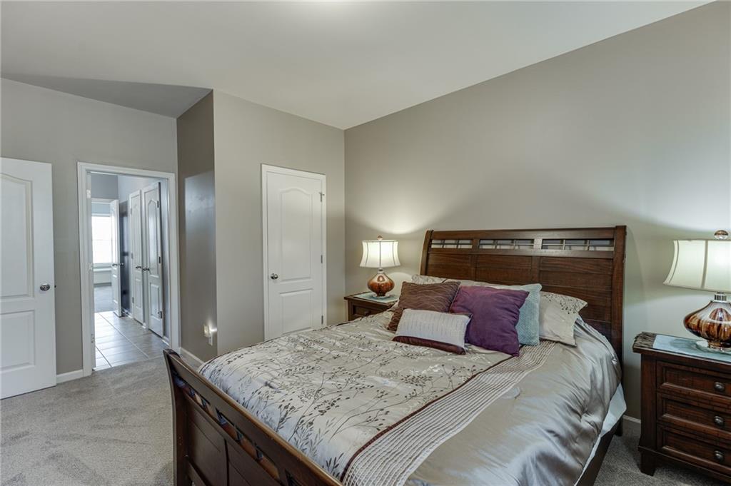 2201 Spring Sound Lane Buford, GA 30519 - Photo 34 of 66 a bedroom with a bed and dresser
