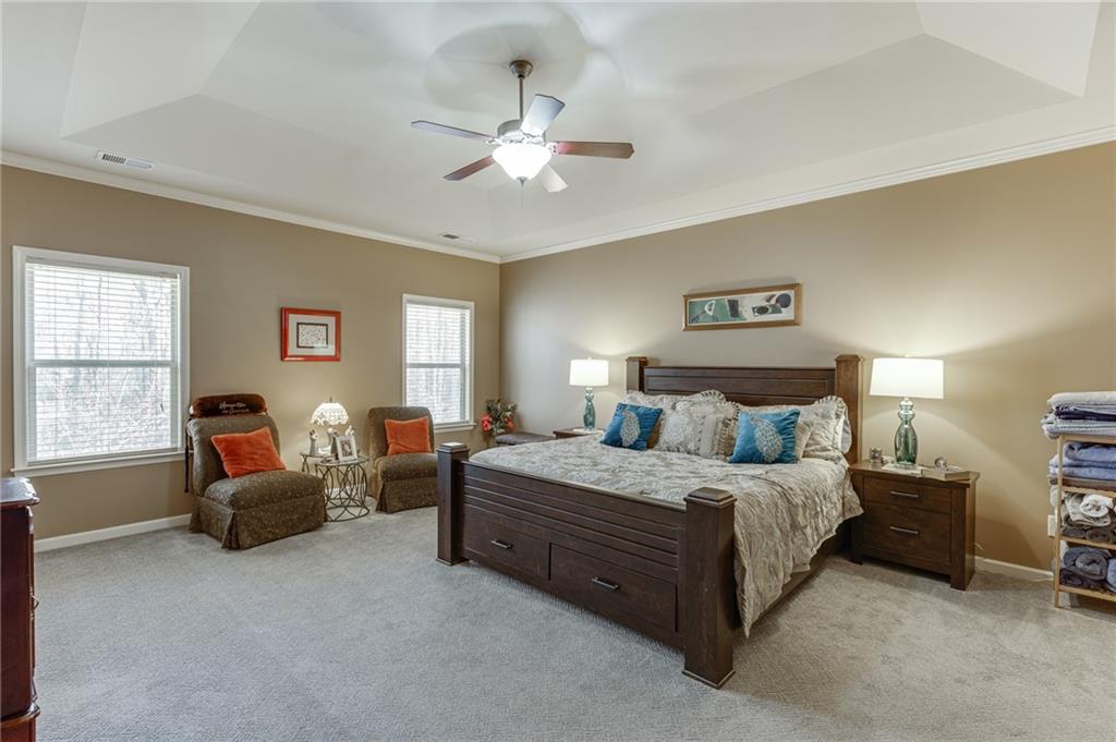 2201 Spring Sound Lane Buford, GA 30519 - Photo 36 of 66 a bedroom with a bed and a chandelier