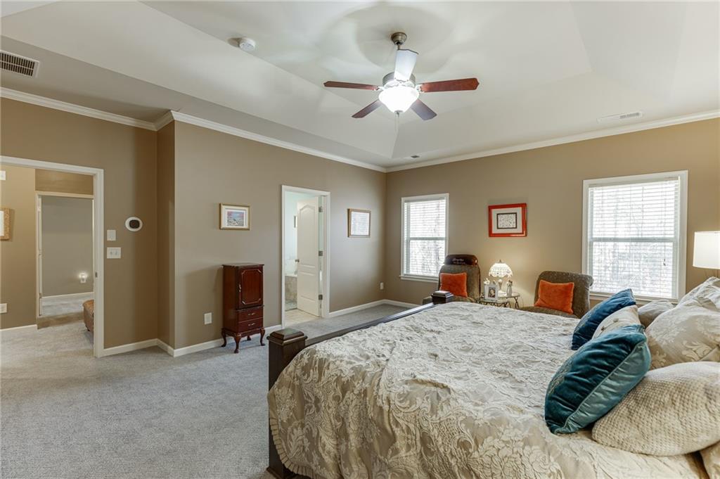 2201 Spring Sound Lane Buford, GA 30519 - Photo 37 of 66 a bedroom with a bed and ceiling fan