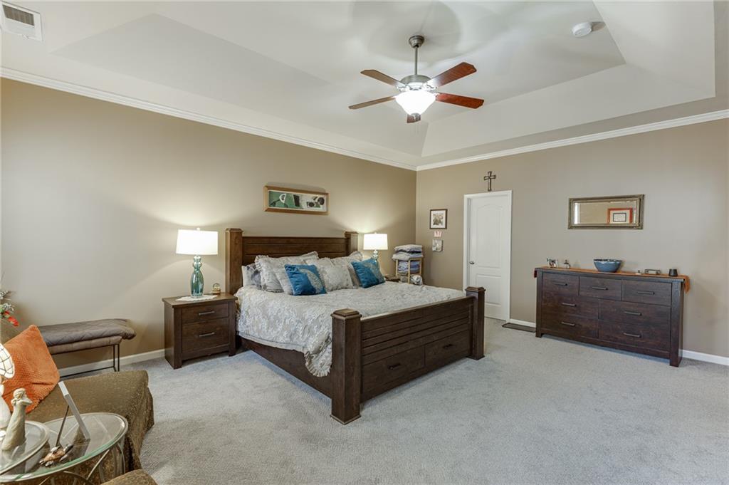 2201 Spring Sound Lane Buford, GA 30519 - Photo 38 of 66 a spacious bedroom with a bed and a chandelier