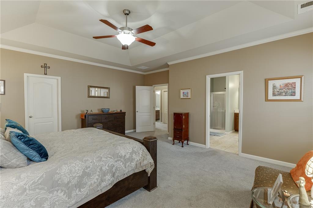 2201 Spring Sound Lane Buford, GA 30519 - Photo 39 of 66 a bedroom with a large bed and a chandelier