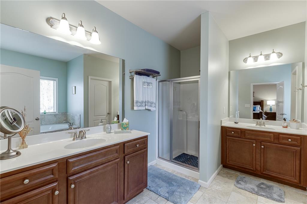 2201 Spring Sound Lane Buford, GA 30519 - Photo 41 of 66 a bathroom with a sink double vanity and a mirror