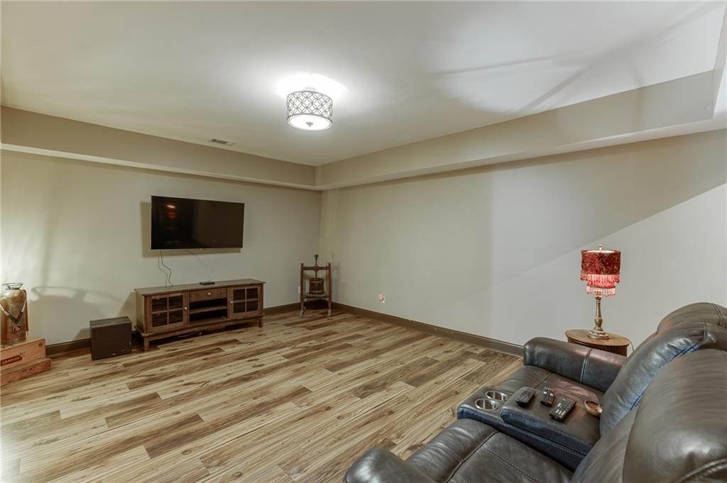 2201 Spring Sound Lane Buford, GA 30519 - Photo 50 of 66 a bedroom with furniture and a flat screen tv