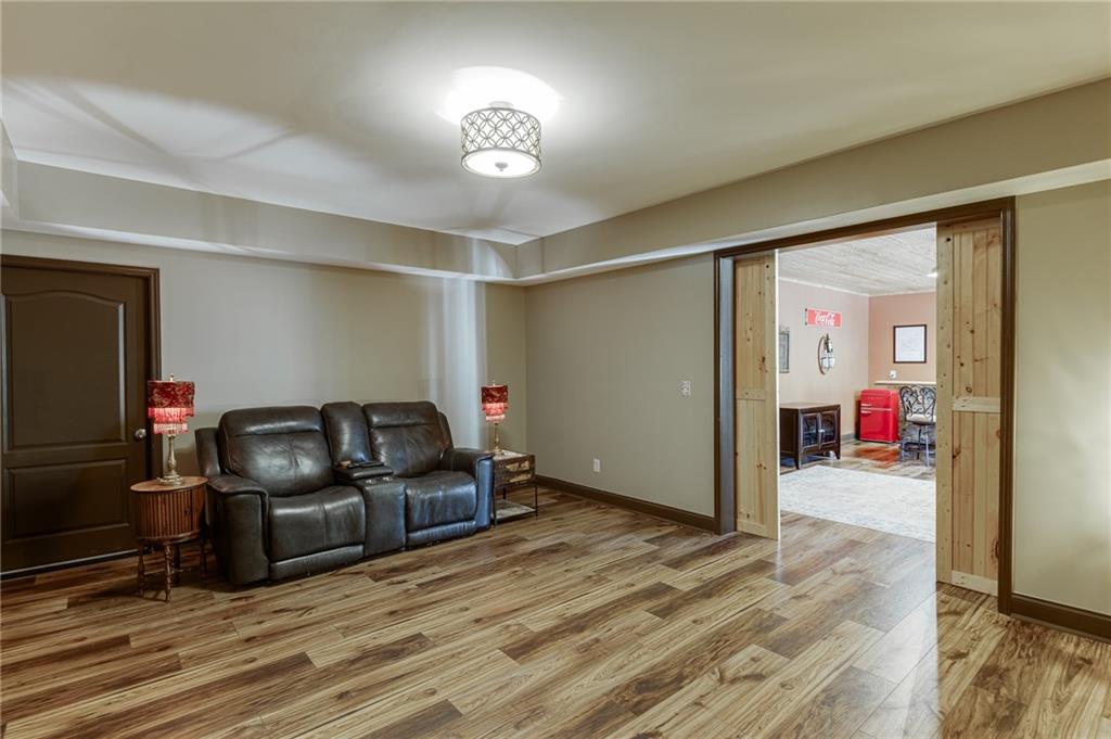2201 Spring Sound Lane Buford, GA 30519 - Photo 52 of 66 a living room with furniture and a wooden floor