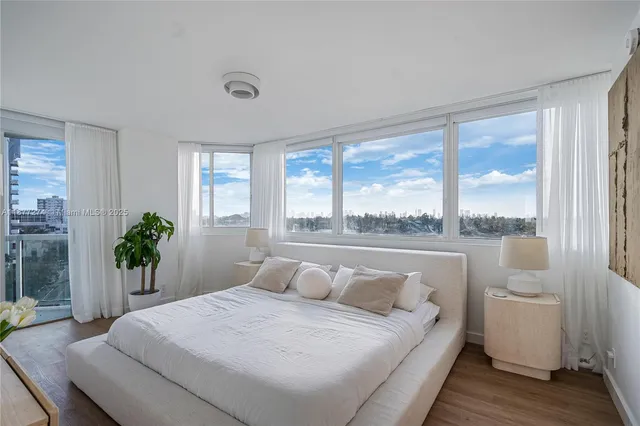 a bedroom with a large bed and a large window