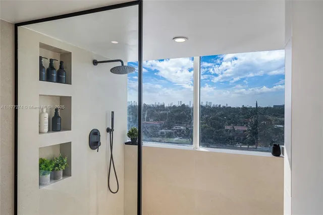 a view of a bathroom with a tub and a shower
