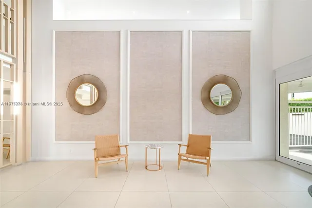 a living room with furniture a window and a clock