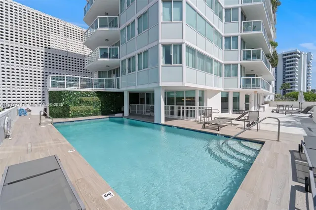a kitchen with a table chairs and a refrigerator