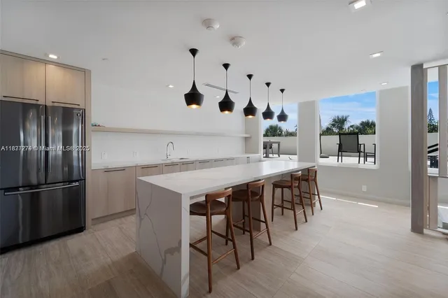 a kitchen with white cabinets and chairs