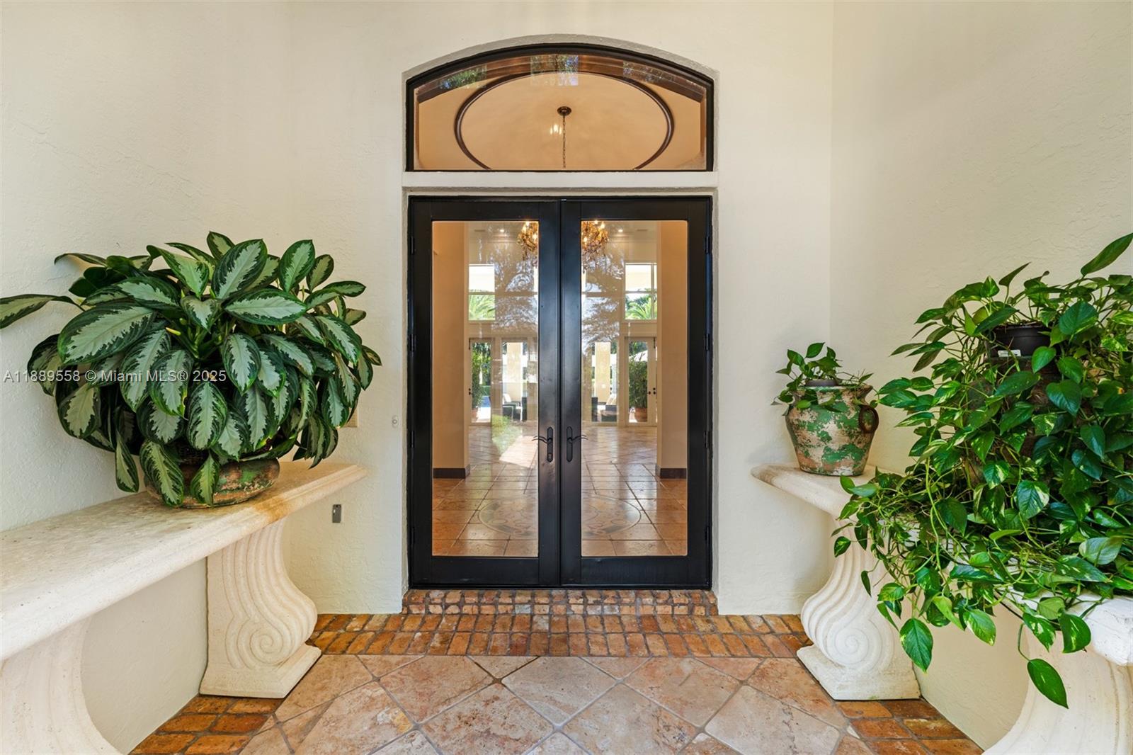 6350 Southwest 92nd Street Pinecrest, FL 33156 - Photo 3 of 41 a front view of a house with a potted plant