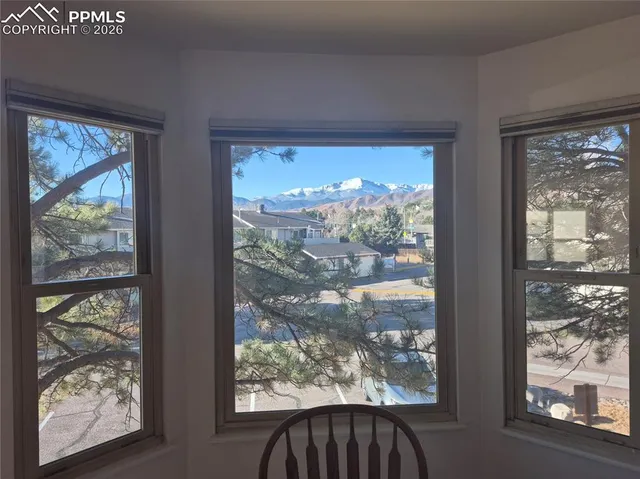 a view of a room with furniture and wooden floor