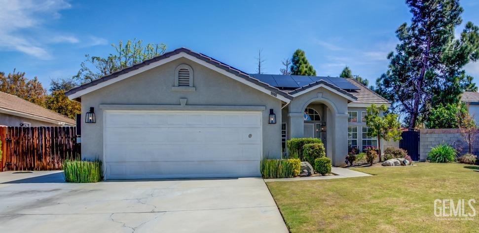 Undisclosed Address Bakersfield, CA 93312 - Photo 1 of 30 a view of a house with small yard plants and a garage