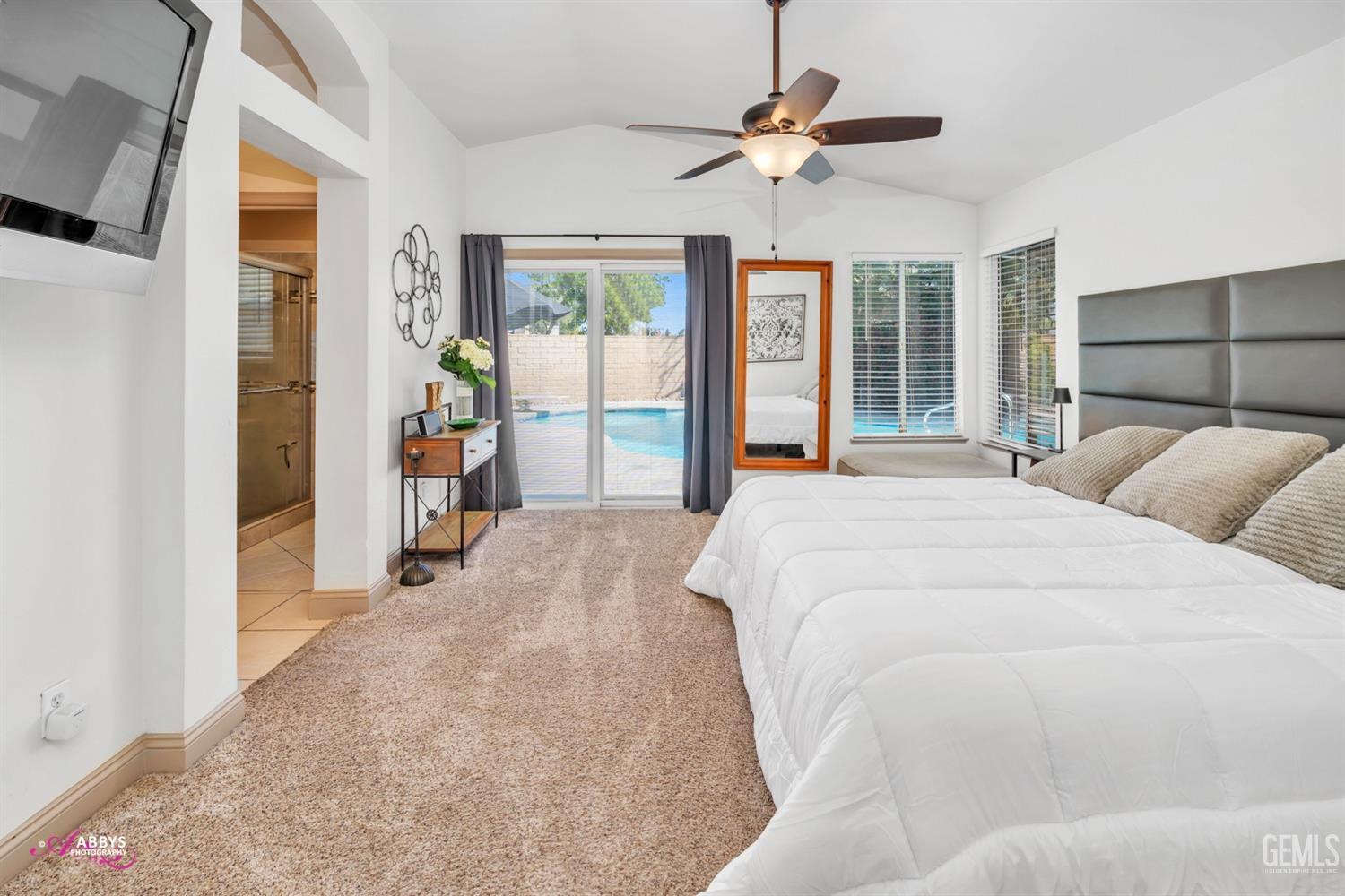 Undisclosed Address Bakersfield, CA 93312 - Photo 11 of 30 a spacious bedroom with a large bed and a chandelier