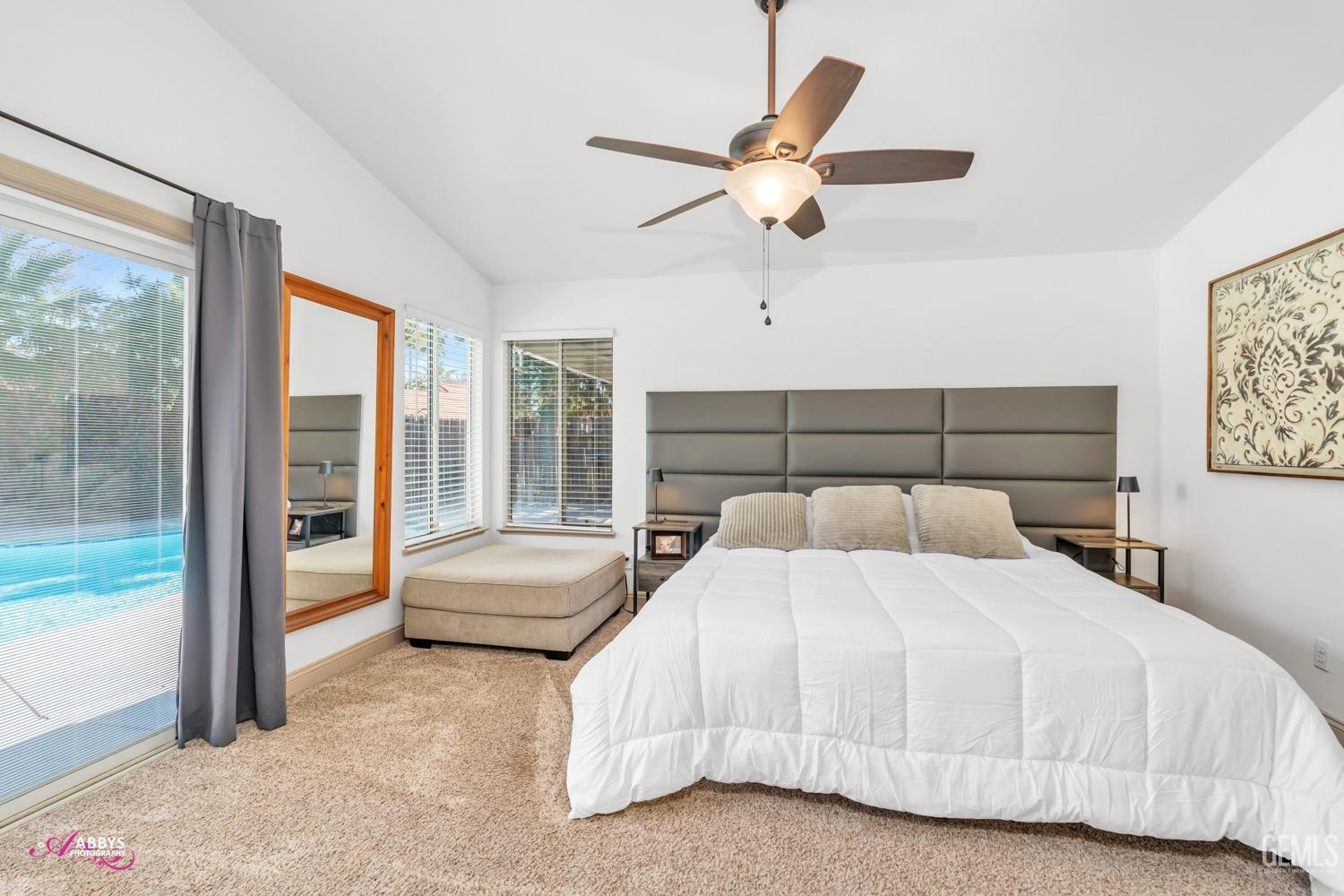 Undisclosed Address Bakersfield, CA 93312 - Photo 12 of 30 a bedroom with a large bed and a chandelier