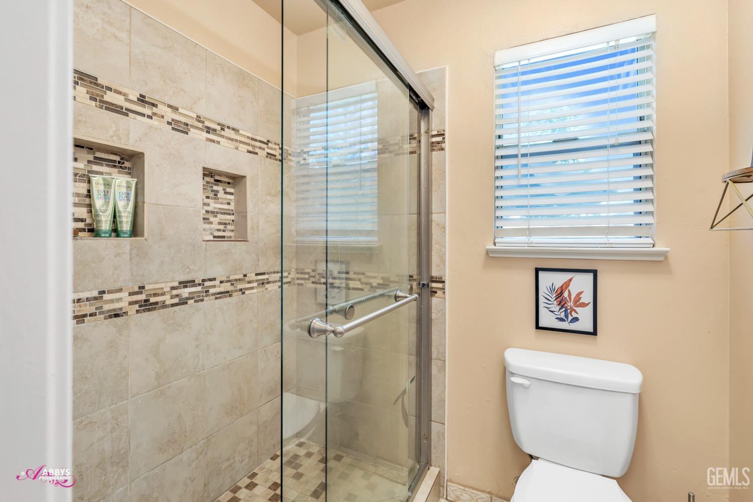 Undisclosed Address Bakersfield, CA 93312 - Photo 14 of 30 a bathroom with a toilet sink and shower