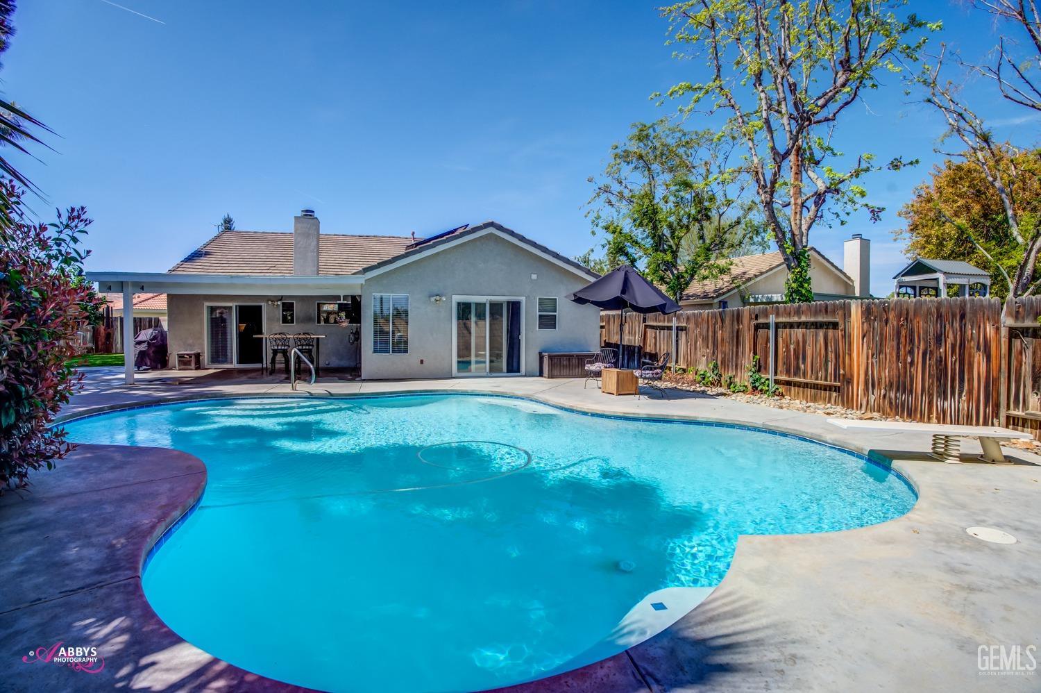 Undisclosed Address Bakersfield, CA 93312 - Photo 20 of 30 a front view of a house with swimming pool having outdoor seating