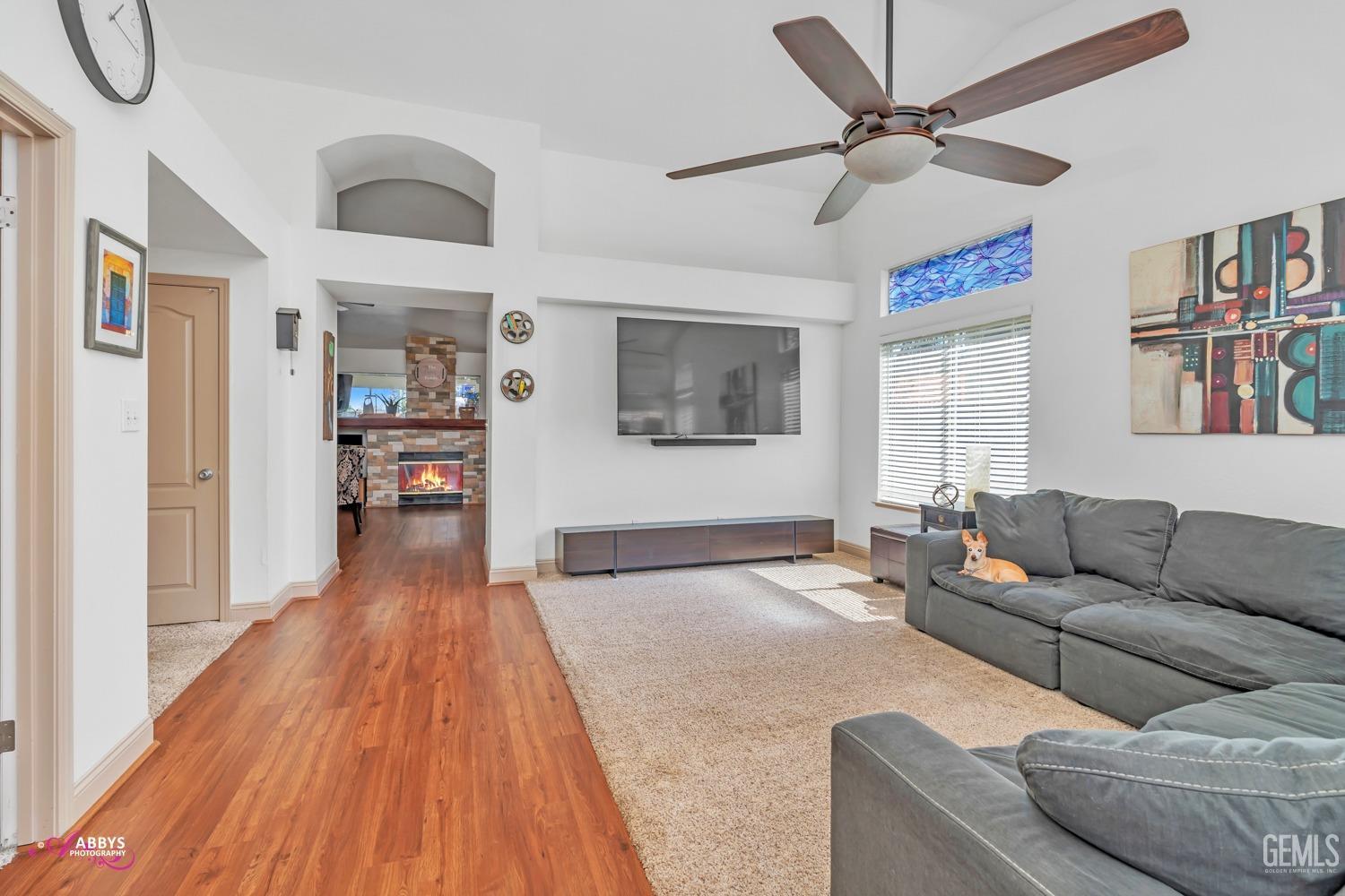 Undisclosed Address Bakersfield, CA 93312 - Photo 3 of 30 a living room with furniture and a wooden floor
