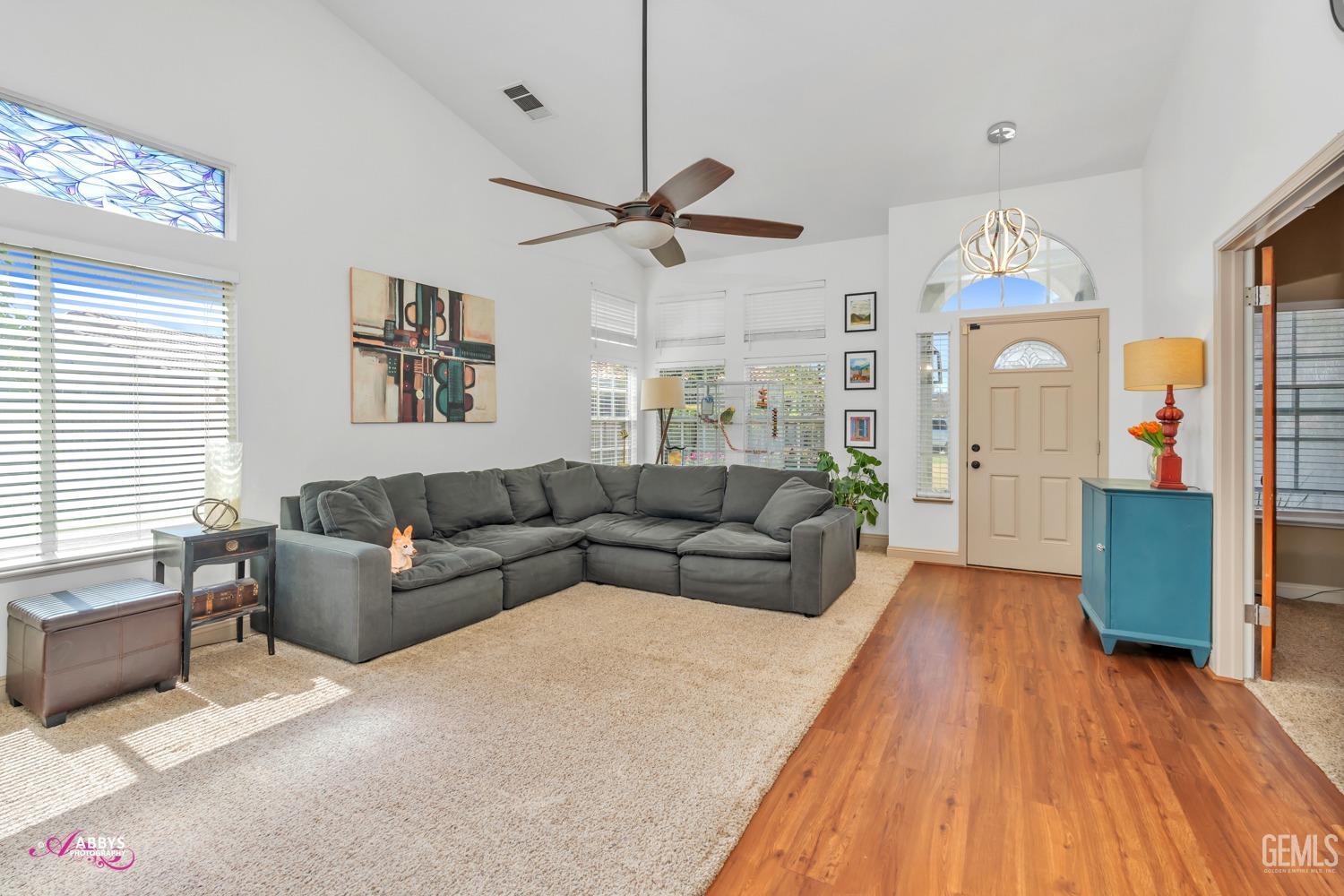 Undisclosed Address Bakersfield, CA 93312 - Photo 4 of 30 a living room with furniture a chandelier and a flat screen tv