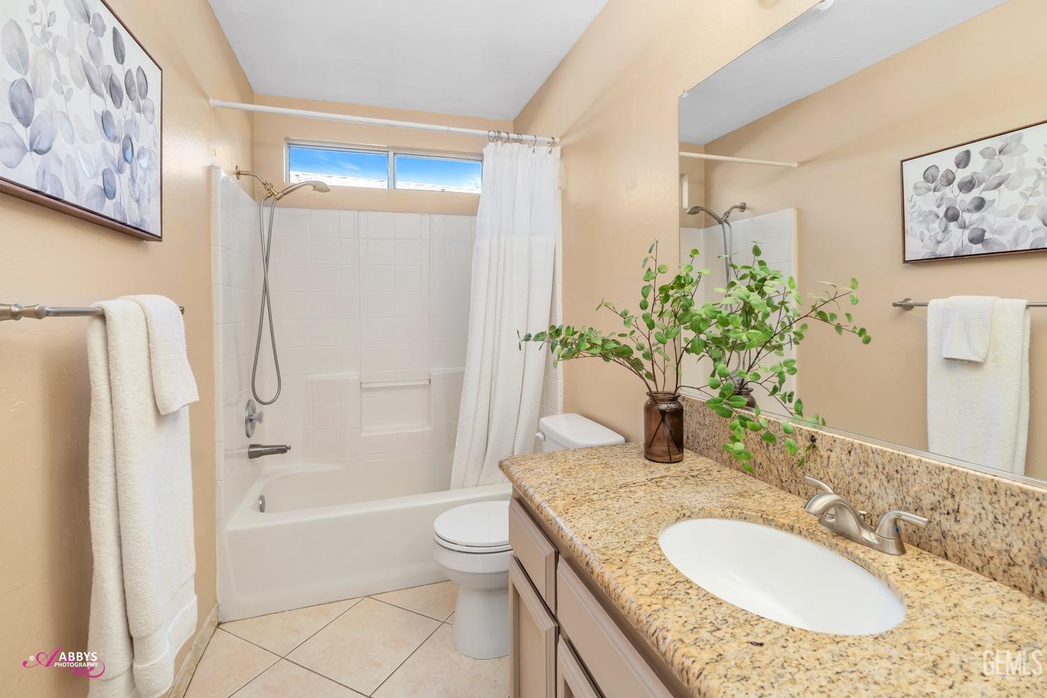 Undisclosed Address Bakersfield, CA 93312 - Photo 9 of 30 a bathroom with a granite countertop sink and a mirror