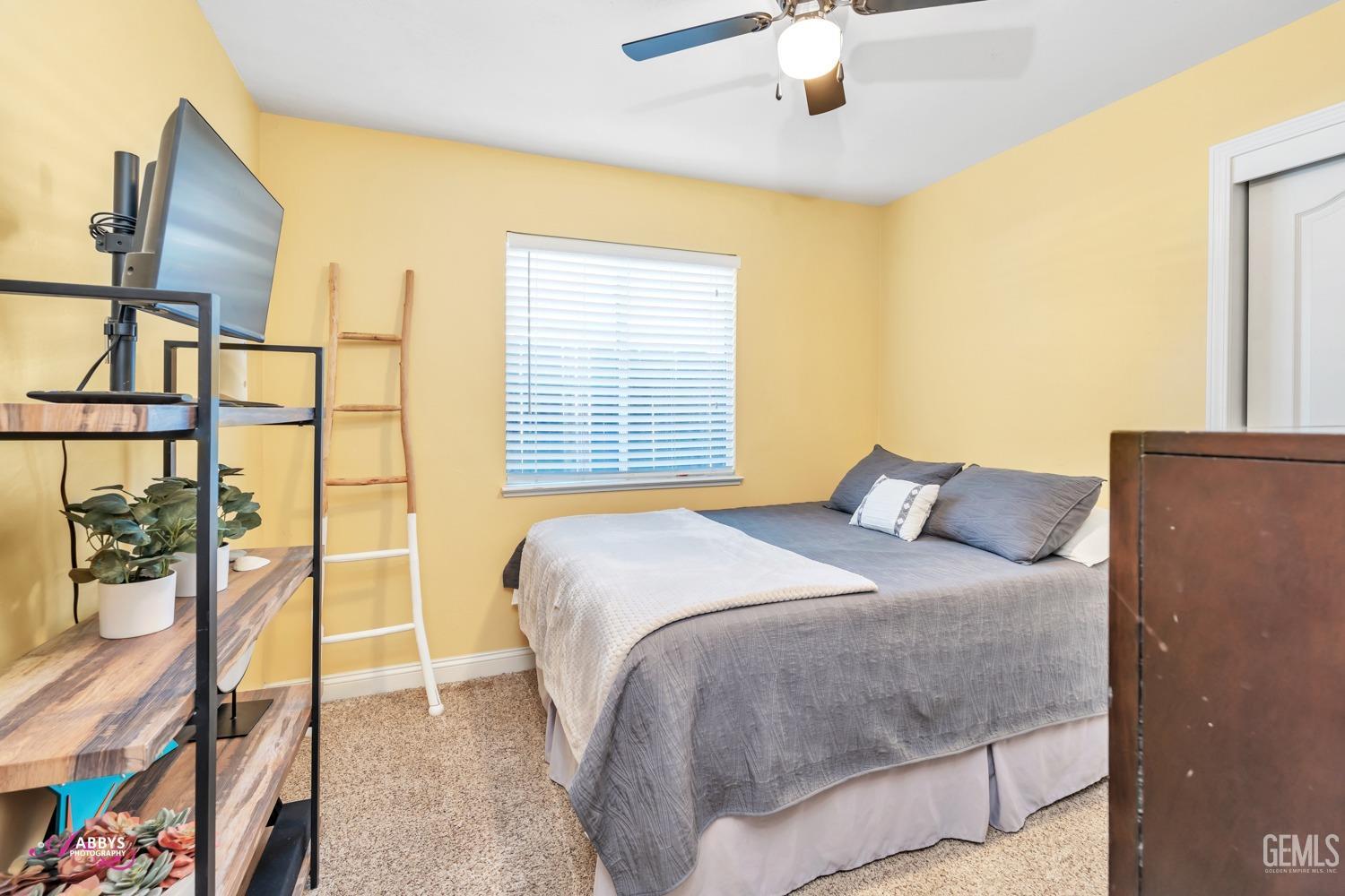 Undisclosed Address Bakersfield, CA 93312 - Photo 10 of 30 a bedroom with a bed and a painting on the wall