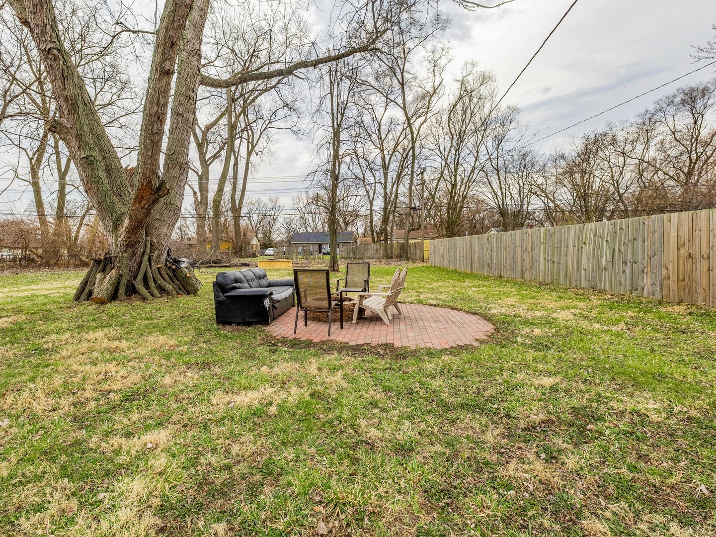 15316 Parkside Drive Markham, IL 60428 - Photo 14 of 14 a view of a backyard with table and chairs and a fire pit