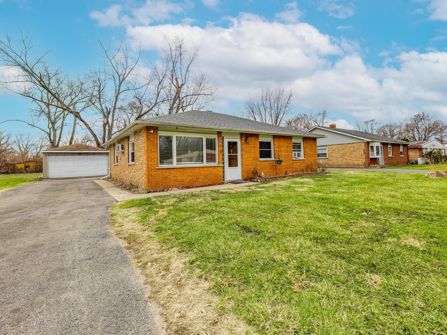 15316 Parkside Drive Markham, IL 60428 - Photo 2 of 14 a front view of house with yard and trees around