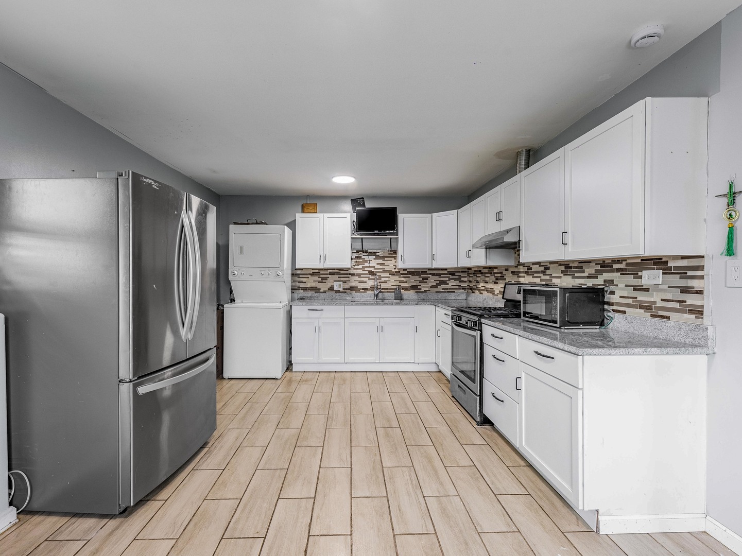 15316 Parkside Drive Markham, IL 60428 - Photo 7 of 14 a kitchen with granite countertop a refrigerator oven a sink dishwasher and white cabinets with wooden floor