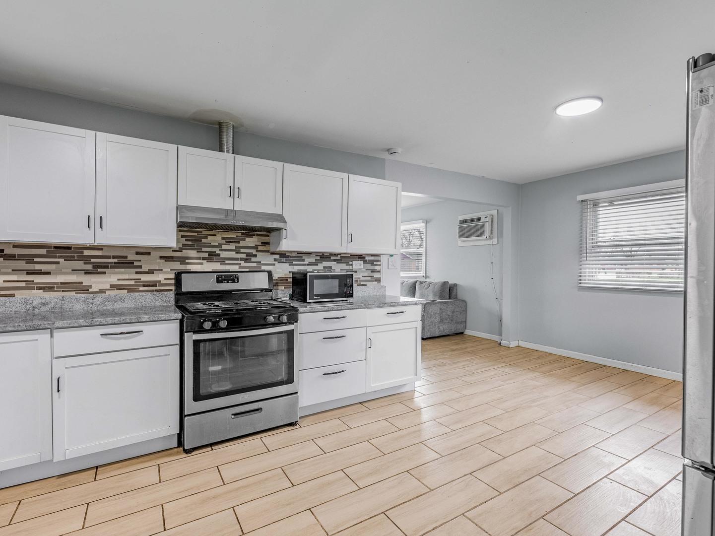 15316 Parkside Drive Markham, IL 60428 - Photo 8 of 14 a kitchen with stainless steel appliances granite countertop a stove a sink and a refrigerator
