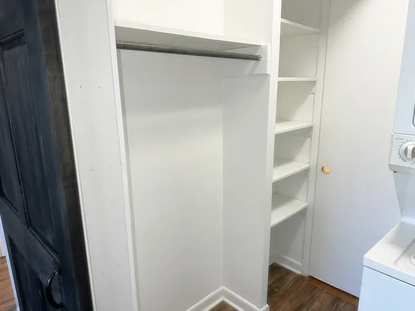 a view of walk in closet with empty racks