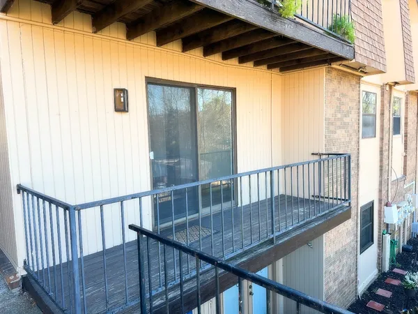 a view of balcony with wooden floor