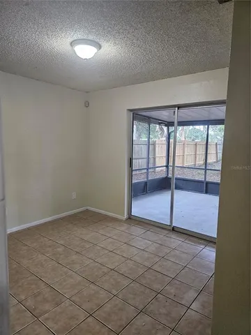 an empty room with sliding glass door and windows