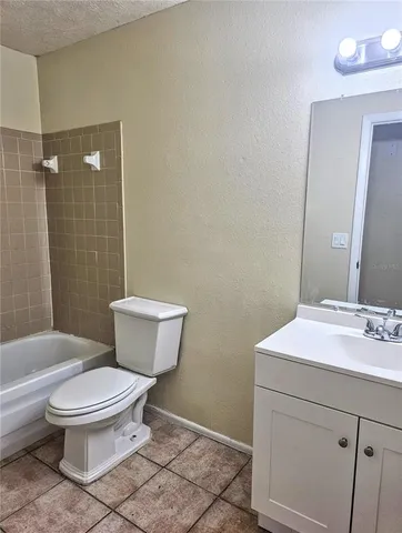 a bathroom with a toilet sink and shower