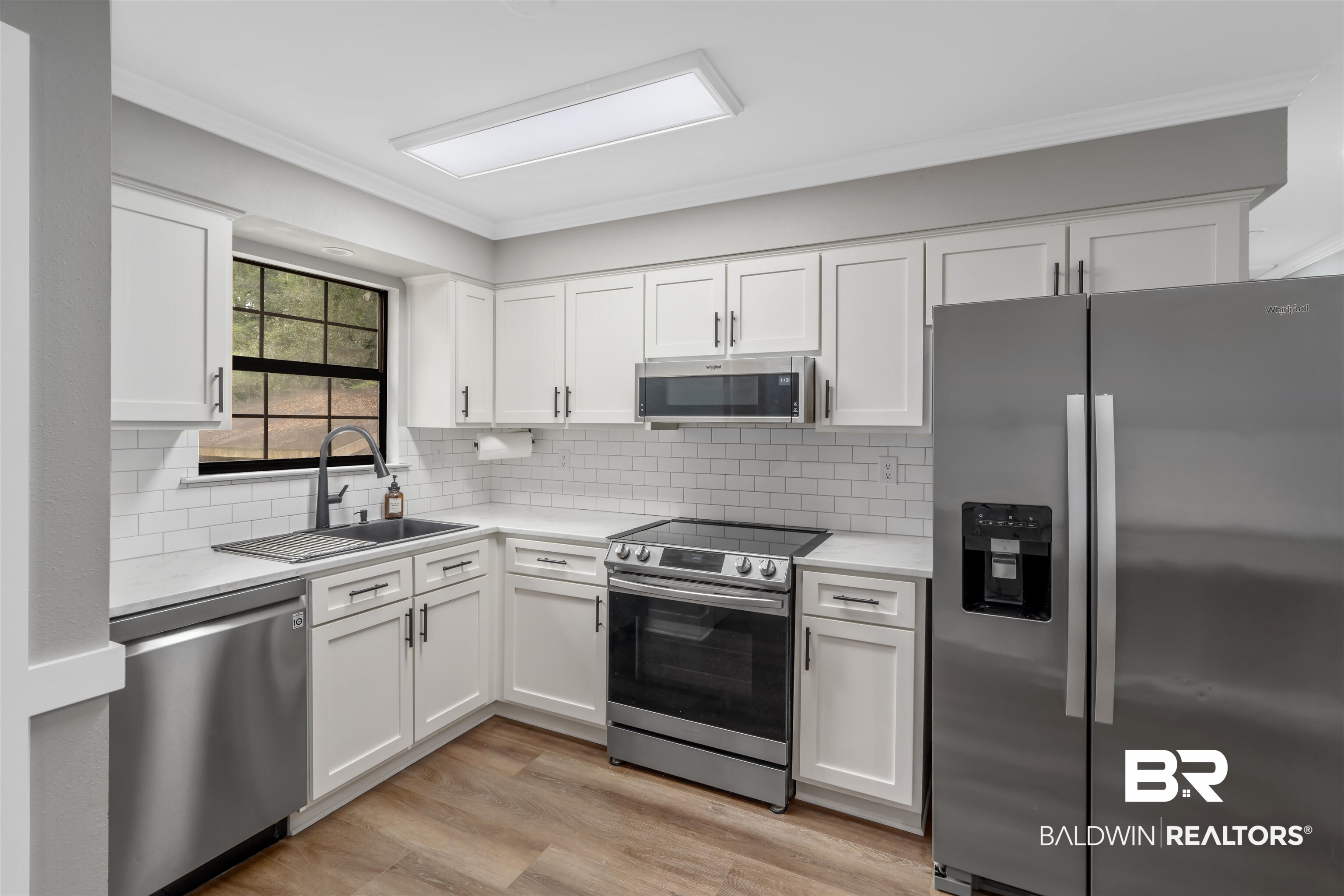 147 Richmond Road Daphne, AL 36526 - Photo 8 of 27 Kitchen with appliances with stainless steel finishes, white cabinetry, backsplash, and ornamental molding