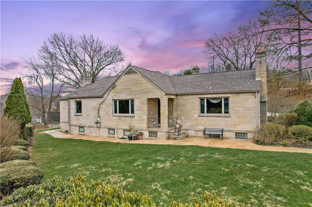 a front view of a house with garden