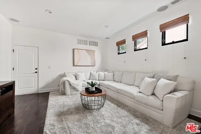 a living room with furniture and a potted plant