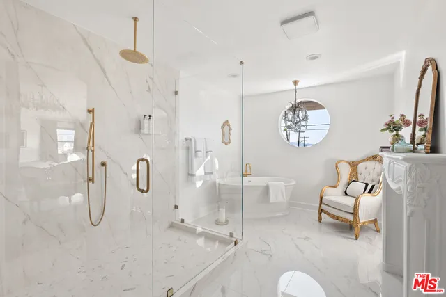 a spacious bathroom with a shower sink and mirror