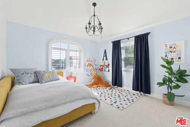 a bedroom with bed and a window