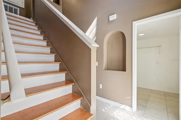 a view of entryway and hall with wooden floor