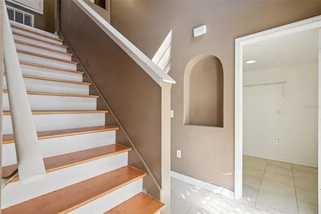 a view of entryway and hall with wooden floor