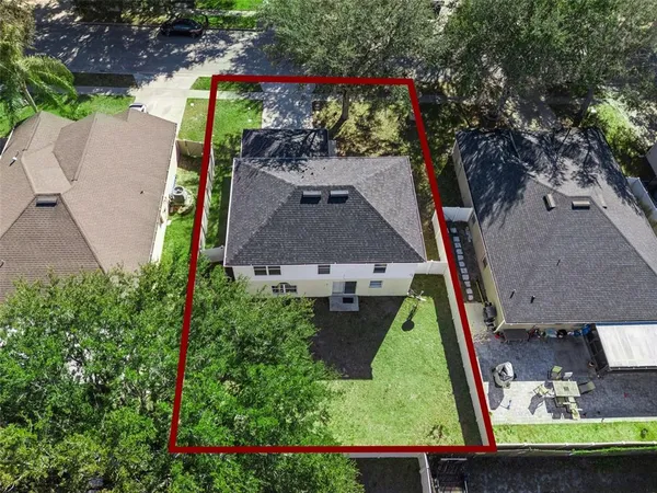 an aerial view of a house with a yard