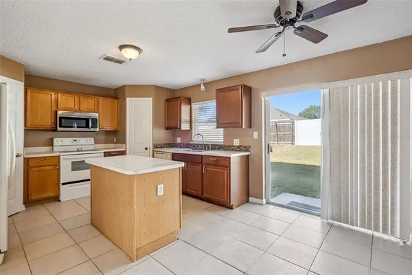 a kitchen with a stove a sink and a refrigerator